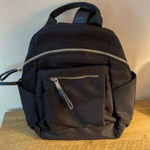 Nylon Black backpack 13”x12” side pockets, inside zipper pockets. Never used.